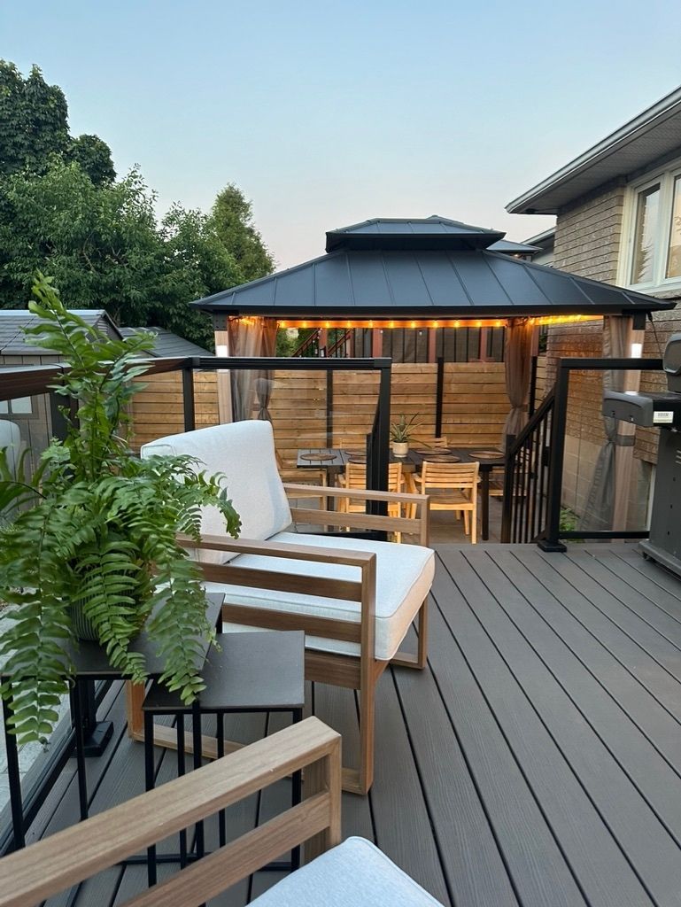 Full view of an elevated outdoor lounge with a modern steel gazebo.